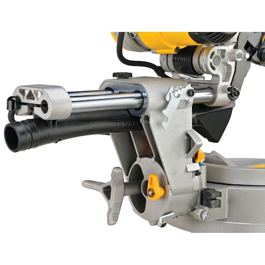 Close-up of the DEWALT DWS780 miter saw, showing the sliding arm mechanism, dust extraction port, and adjustment levers.