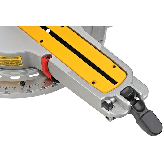 Close-up view of a DEWALT miter saw adjustment arm with a yellow and silver finish, featuring a red angle indicator and black adjustment handle.