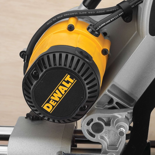 Close-up view of the motor assembly of a DEWALT power tool, featuring a yellow and black housing with visible brand logo and metal components.