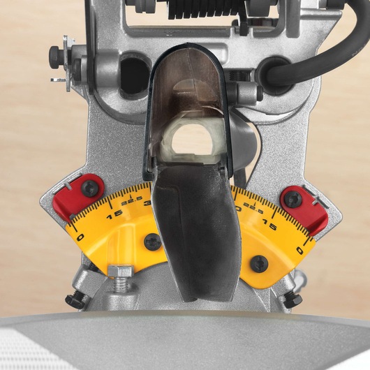 Close-up view of a DEWALT DWS780 miter saw showing the yellow angle measurement scale with red adjustment locks and metal components.