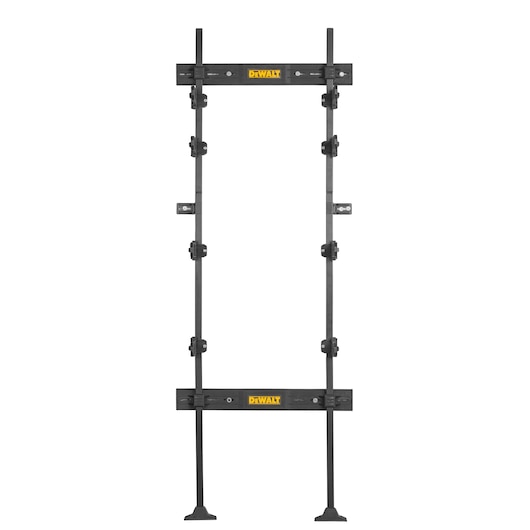 A DEWALT door installation kit with adjustable metal bars, clamps, and support feet, designed for precise and secure door framing.