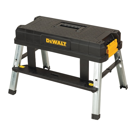 A DEWALT-branded black and yellow portable sawhorse and tool storage box with metal folding legs, designed for use in construction or workshop settings.
