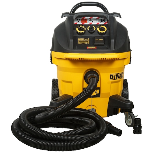 A DEWALT industrial vacuum cleaner with a yellow and black body, large wheels, control panel, and a long black hose coiled in front. The product is shown with attachments and labeled controls.