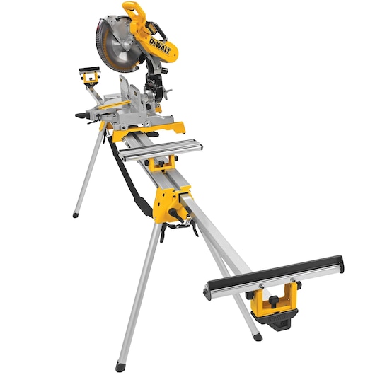 A DEWALT miter saw mounted on a sturdy metal stand with adjustable arms and support brackets. The saw has a yellow and black design and features a circular blade. The stand includes foldable legs and extension supports for holding long pieces of material.