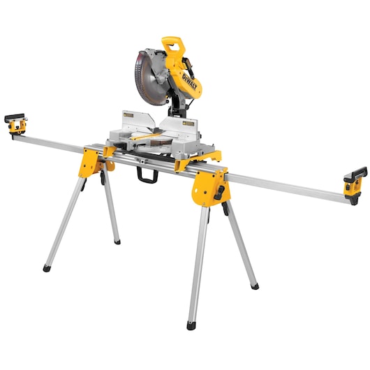 A DEWALT miter saw mounted on a yellow and silver portable stand with extendable arms and foldable legs.