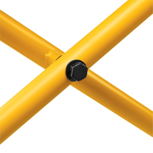 Close-up of two intersecting yellow metal tubes fastened together with a black bolt.