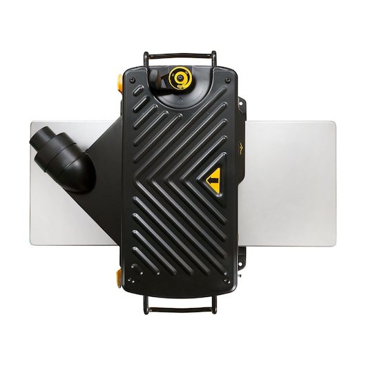 Top view of a DEWALT DW733 planer, featuring a black housing with diagonal grooves, a yellow adjustment knob, dust extraction port on the left, and silver-colored extension tables on both sides.