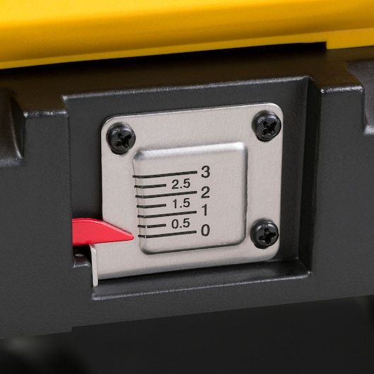 Close-up of a metal depth gauge with black markings ranging from 0 to 3, securely attached with four screws. There is a red indicator pointing at the scale. The device features yellow and black parts.