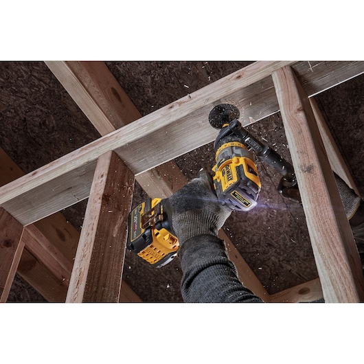 Brushless 18V XR XRP hammer drill driver cutting a hole in wooden framework