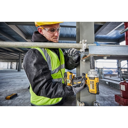 CORDLESS IMPACT WRENCH WITH DETENT PIN ANVIL being used on a tire