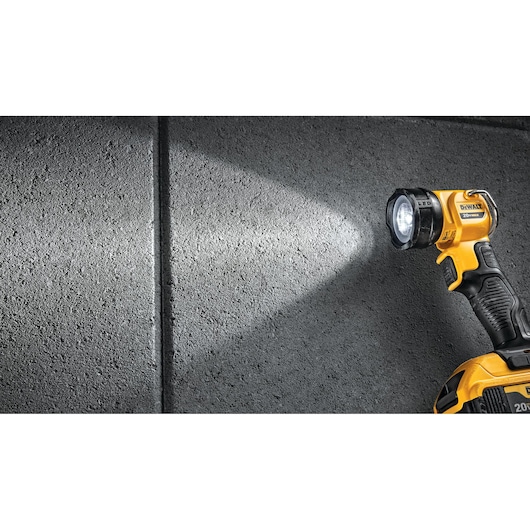 Flashlight feature of a LED work light next to a concrete wall