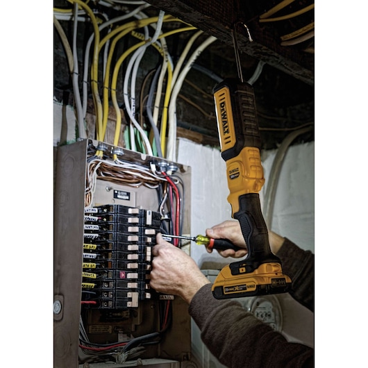 LED hand held area light being used by a person