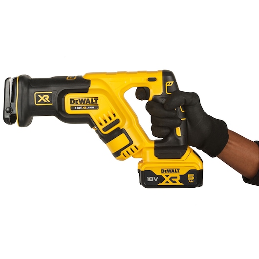 Gloved hand holding 18V XR Brushless Reciprocating Saw with 5.0Ah Powerstack battery