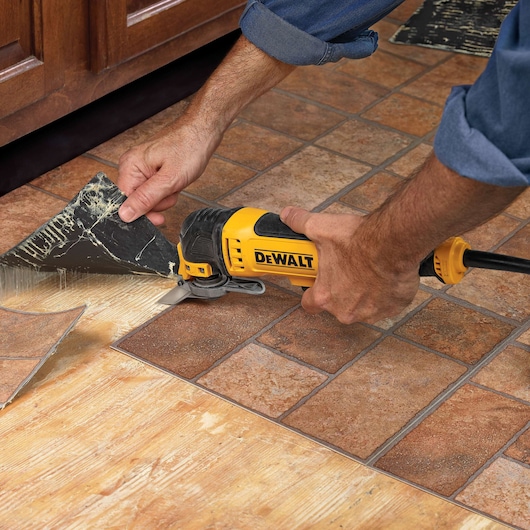 the 2 inch Oscillating Rigid Scraper Blade being used on a floor.